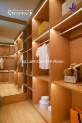 Walk-in closet with wooden shelves and storage boxes