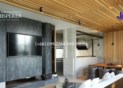 Modern living room with wooden ceiling and wall-mounted TV