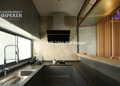 Modern kitchen with sleek cabinetry and large window