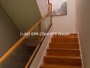 Staircase with wooden steps and glass railing in a modern interior