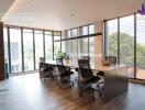 Modern office space with large windows, conference table, and ergonomic chairs