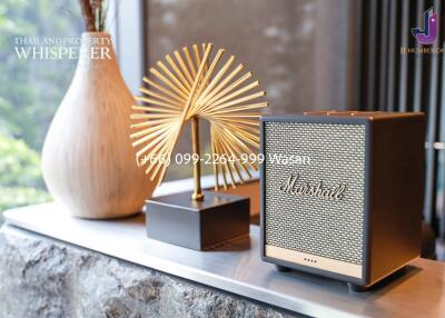 Decorative items on a shelf including a Marshall speaker and a golden sculpture