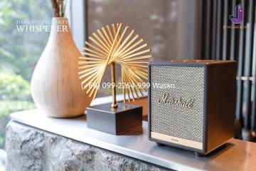 Decorative items on a shelf including a Marshall speaker and a golden sculpture