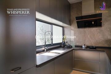 Modern kitchen with large window and sleek cabinets