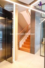 Modern staircase with wood steps and glass panels