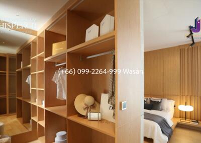 Spacious bedroom with wooden wardrobes and neatly arranged furniture