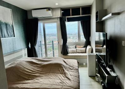 Modern bedroom with large window and city view