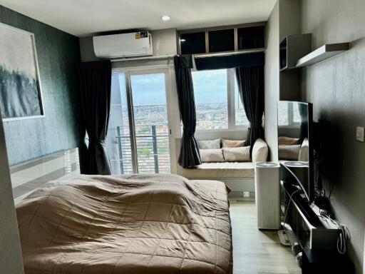 Modern bedroom with large window and city view