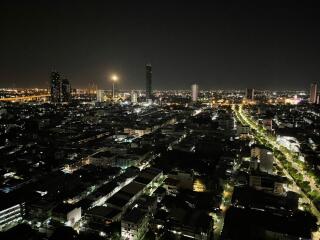 Nighttime cityscape with illuminated buildings and streets