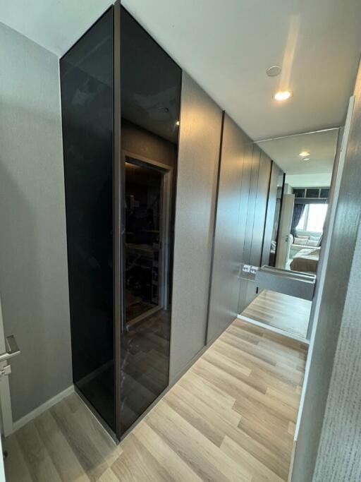 Modern hallway with mirror and wooden flooring