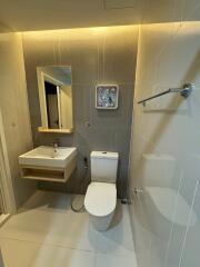 Modern bathroom with sink, toilet, and mirror