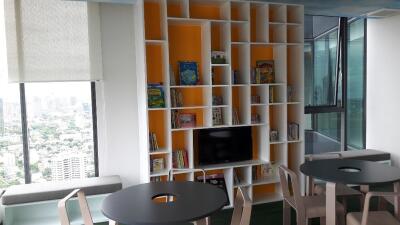 Living room with modern shelving unit and city view