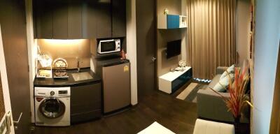 Modern living area with integrated laundry and kitchenette