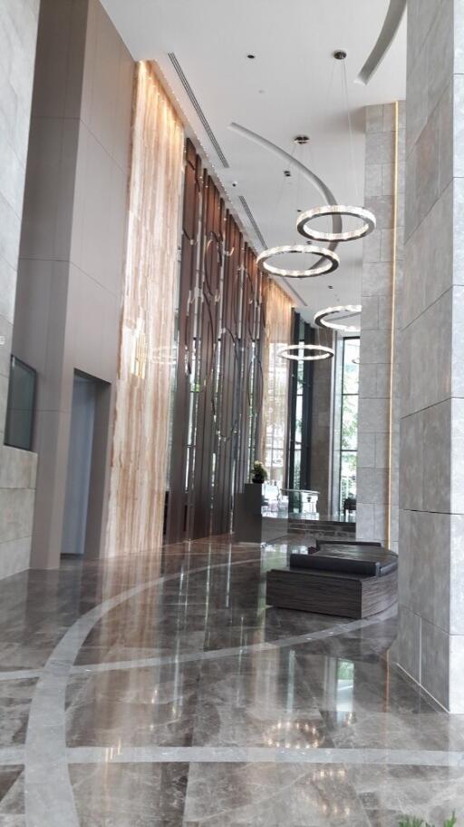 Modern and luxurious lobby with marble flooring and elegant lighting fixtures