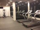 Modern fitness center with treadmills and elliptical machines