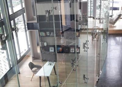 Modern living area with glass staircase and city view