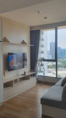 Modern living room with large window and city view