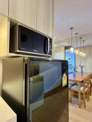 Modern kitchen with dining area featuring wooden table and chairs