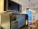 Modern kitchen with dining area featuring wooden table and chairs