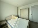 Bright bedroom with a double bed and wardrobe