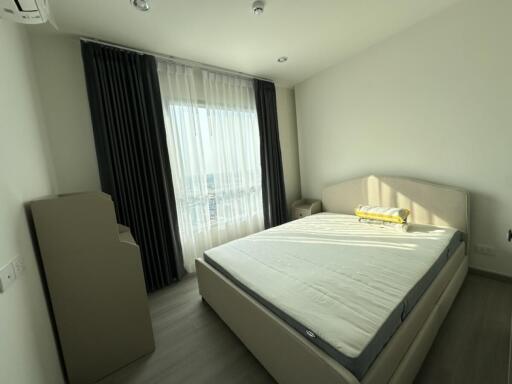 Bedroom with a large window and modern furniture