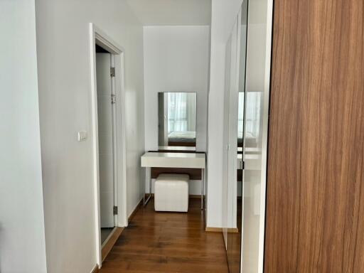 Vanity area in a modern bedroom with wooden floors and large mirror