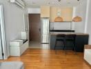 Modern living room with adjoining kitchen and wooden flooring