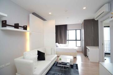 Modern living area with visible bedroom