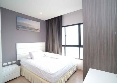 Modern bedroom with a large window and minimalistic decor