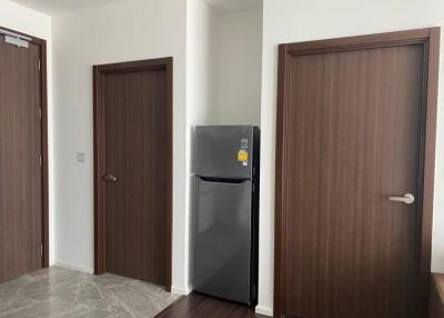 Hallway with fridge and wooden doors