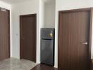 Hallway with fridge and wooden doors