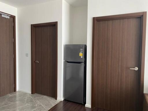 Hallway with fridge and wooden doors