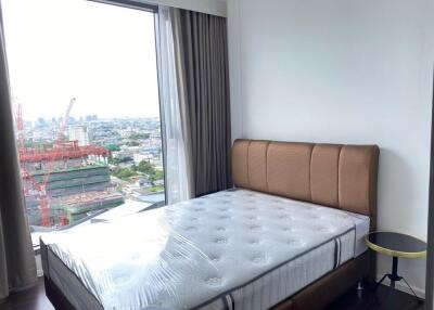 Bedroom with large window and city view