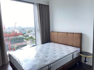 Bedroom with large window and city view