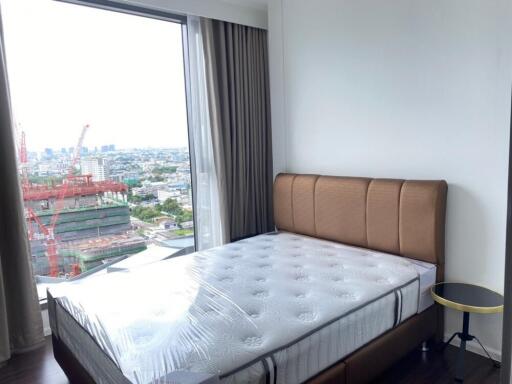 Bedroom with large window and city view