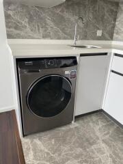 Modern kitchen with built-in washer and sleek countertop