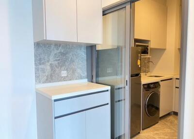 Modern kitchen with built-in appliances and laundry area