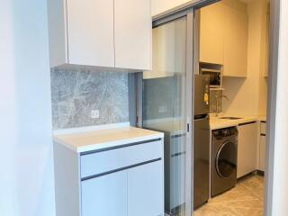 Modern kitchen with built-in appliances and laundry area