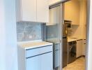 Modern kitchen with built-in appliances and laundry area