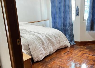 Cozy bedroom with wooden flooring