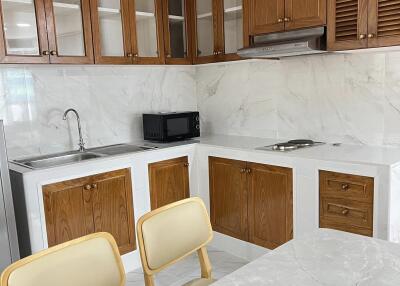 kitchen with wooden cabinets and marble countertop