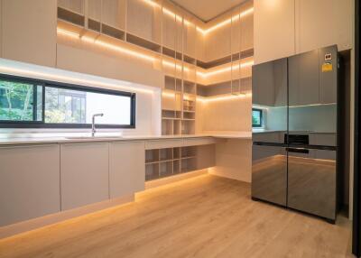 Modern minimalist kitchen with built-in cabinets and large refrigerator