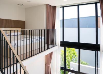 Modern living space with loft area and large windows