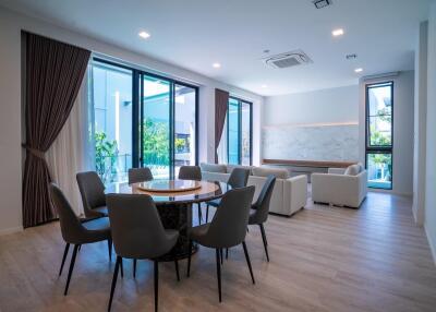 Modern living room with dining area and large windows