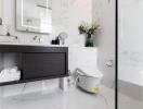 Modern bathroom with vanity, toilet, and floral decoration