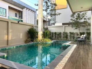 Luxury outdoor pool with modern fencing and greenery