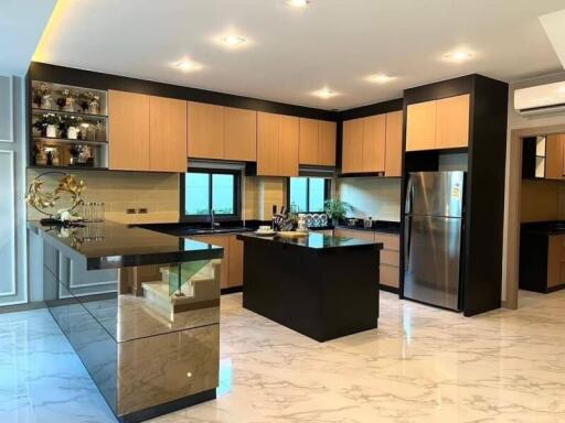 Modern kitchen with marble flooring and wooden cabinets