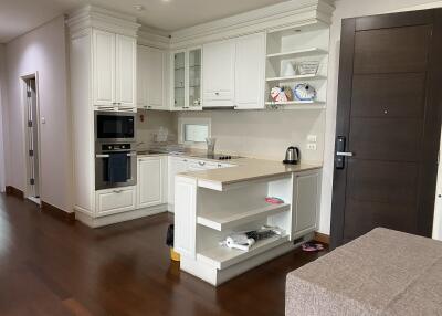 Modern kitchen with white cabinetry and built-in appliances