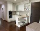 Modern kitchen with white cabinetry and built-in appliances