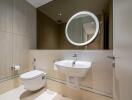 Modern bathroom with wall-mounted toilet, sink, and mirror